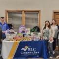 A group of BLC Employees show off the donations that were made to the Back to School Drive
