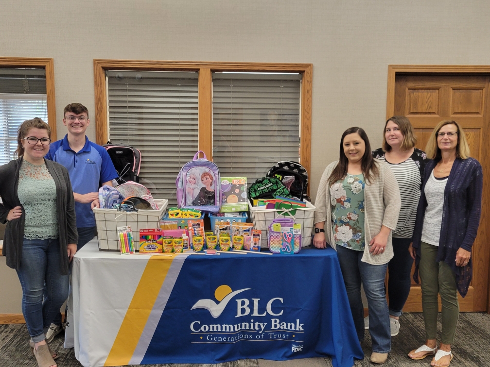 A group of BLC Employees show off the donations that were made to the Back to School Drive